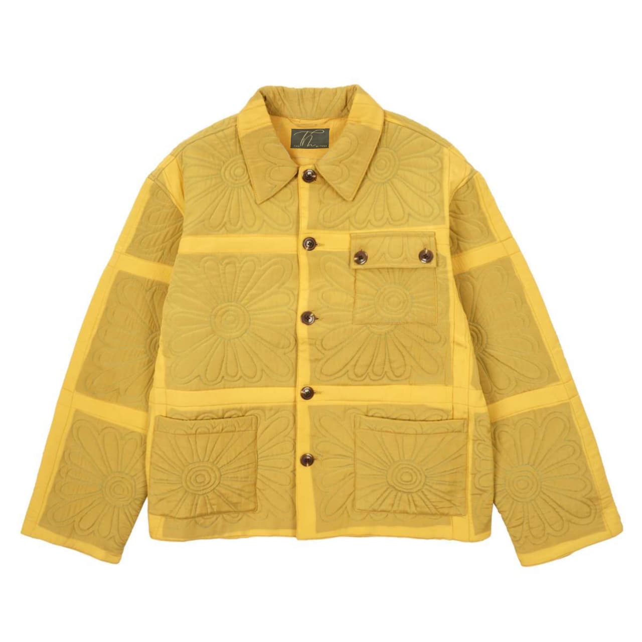 Yellow quilted jacket with decorative patterns on a white background