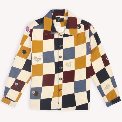 A unisex patchwork embroidered shacket with a geometric pattern in multicolor, featuring hand-embroidered motifs of animals and nature-inspired designs.