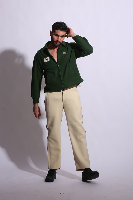 Man wearing a green jacket and beige pants on a white background
