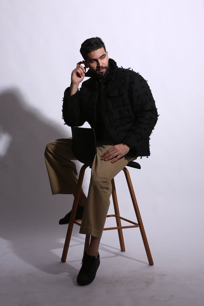 Person sitting on a stool with a white background