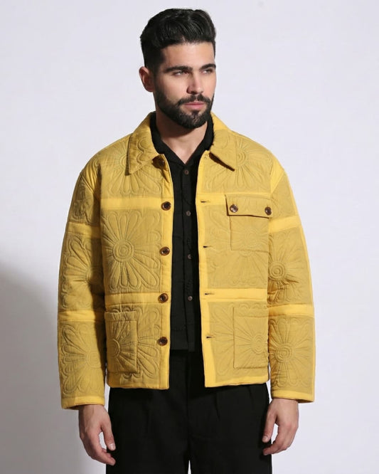 Man wearing a yellow quilted jacket on a white background
