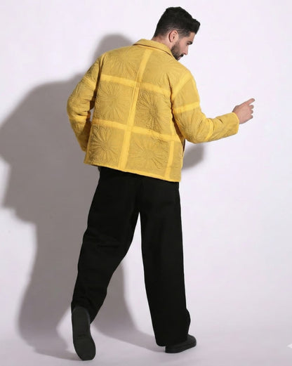 Person wearing a yellow jacket with a grid pattern on a white background