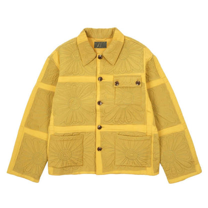 Yellow quilted jacket with decorative patterns on a white background